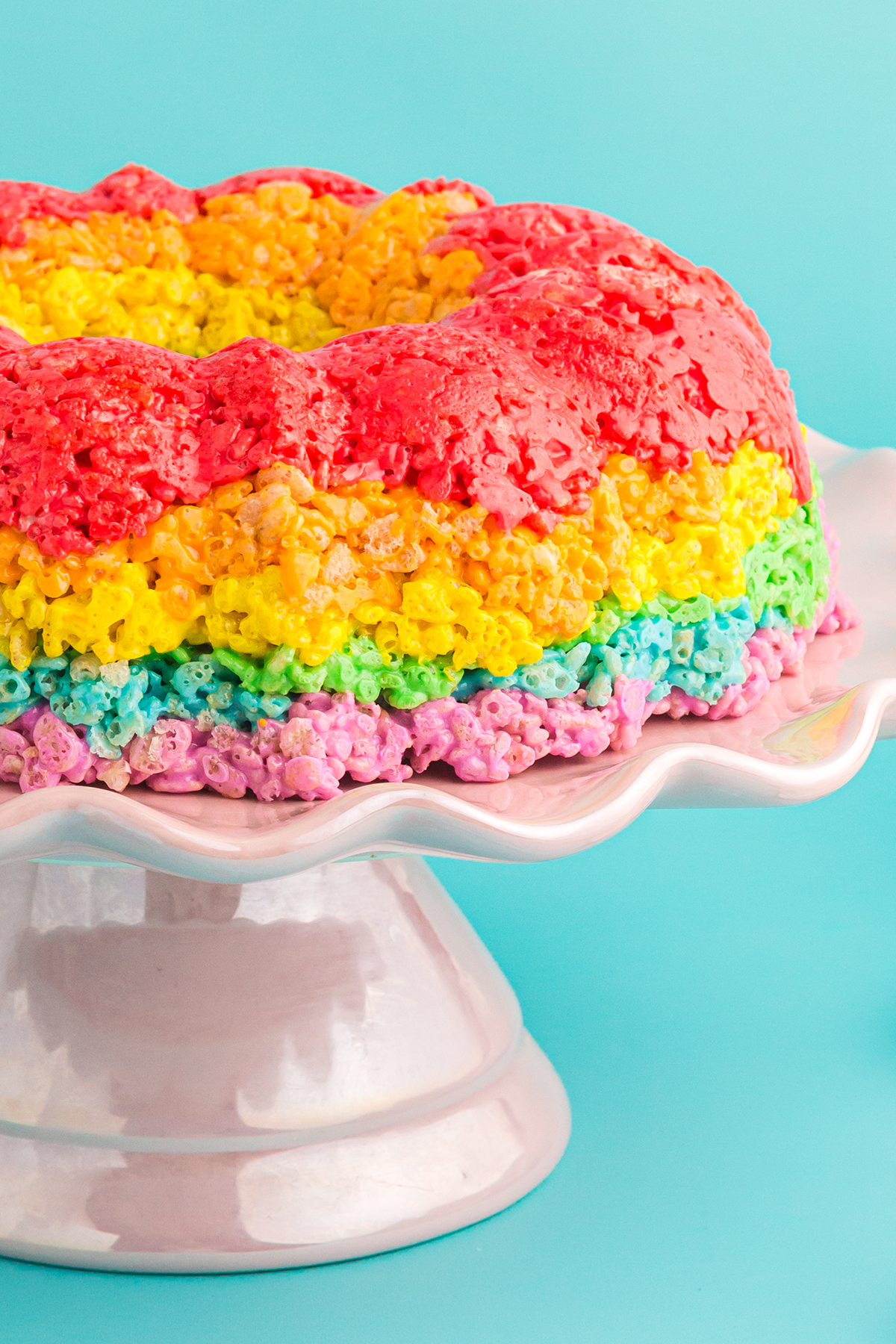 Rainbow Rice Krispies Bundt Cake on a cake server