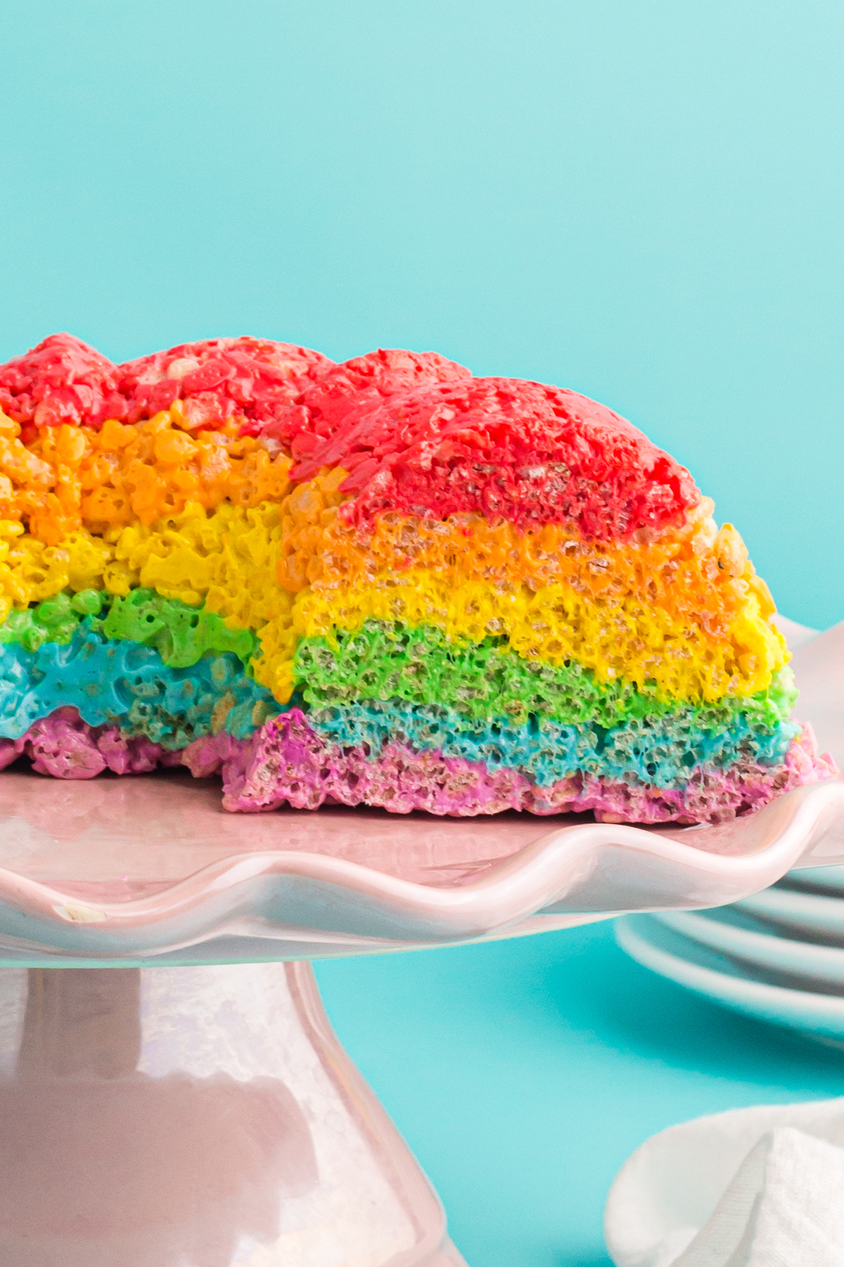 sliced open rainbow bundt cake on a cake server