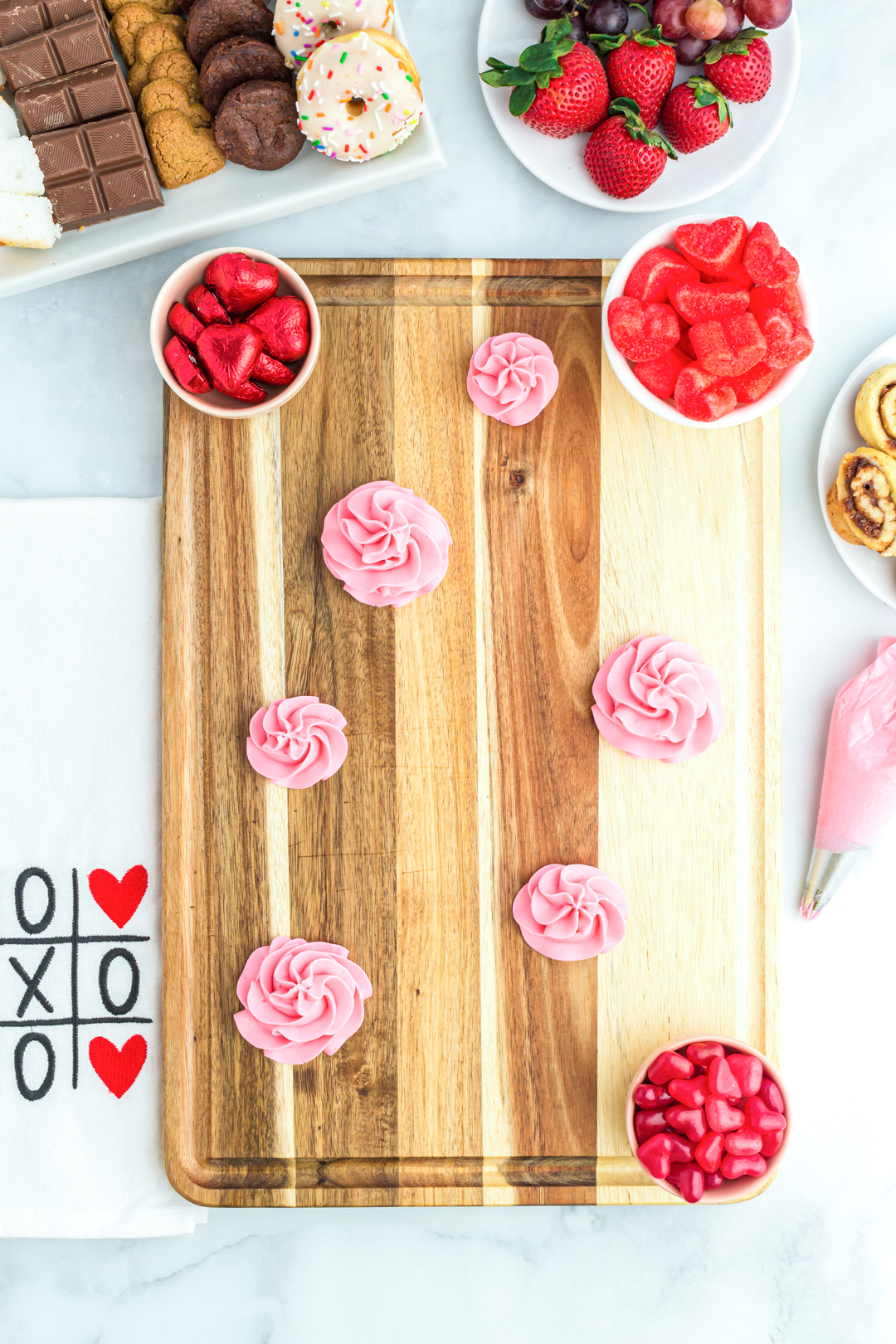 Delicious pink rosettes were artfully arranged to adorn a dessert grazing board, creating delectable excitement for what was soon to come.