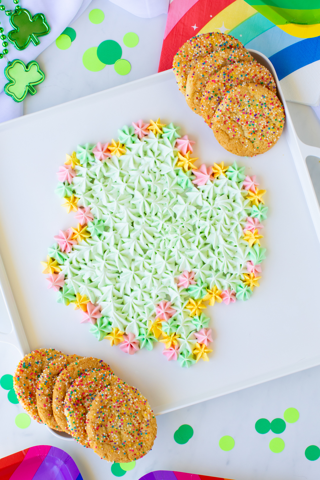 cute shamrock dip on a white tray served with cookies