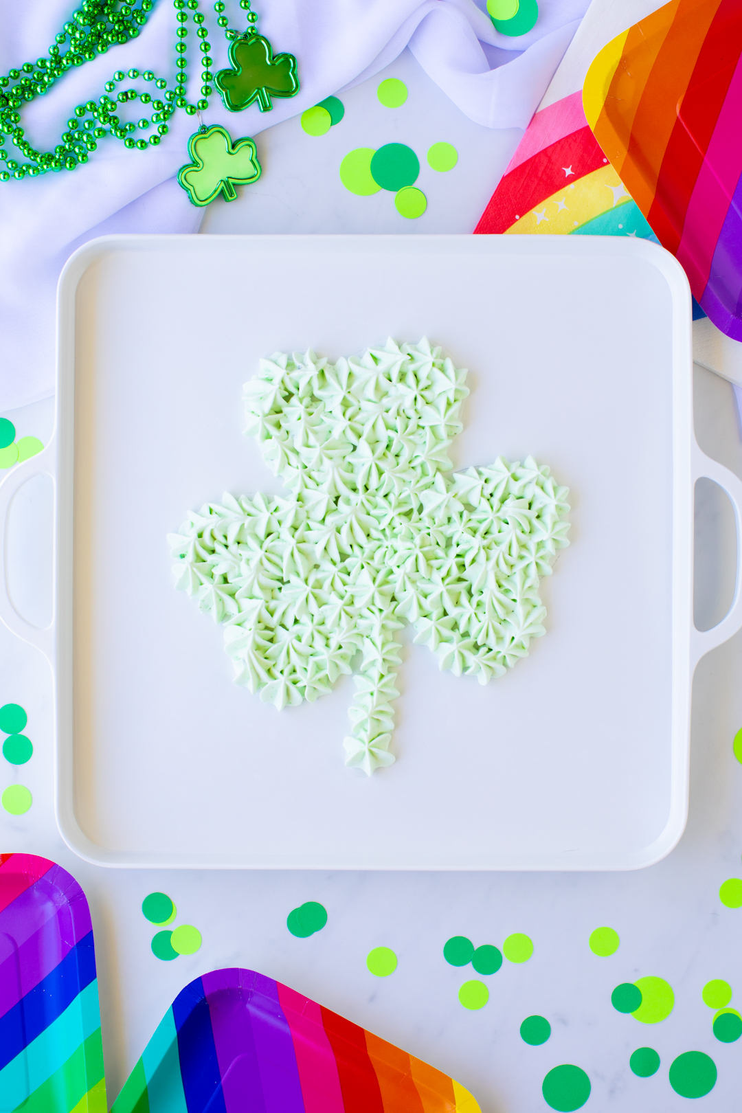 a simple light green shamrock piped onto a serving try using pistachio dip
