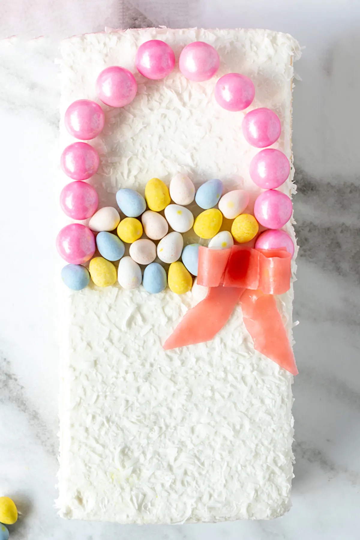 making an easy easter basket cake using candy, gumballs and fruit snacks