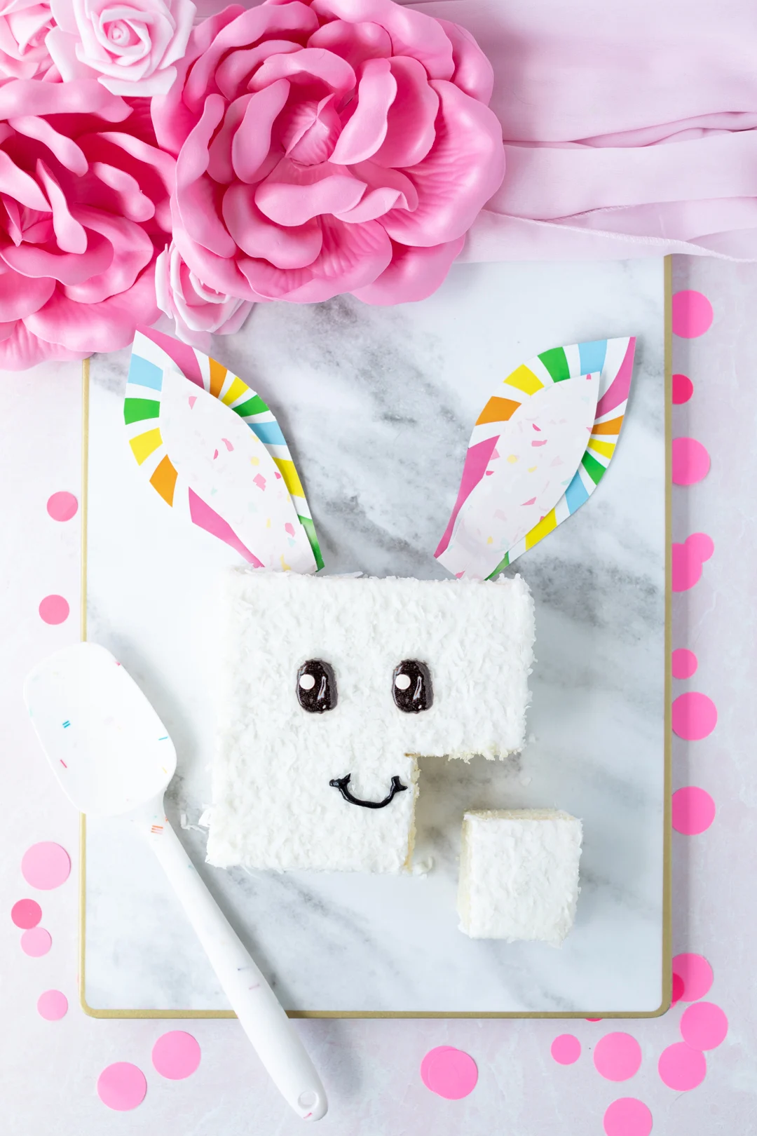 easy easter bunny cake using a store-bought coconut cake and paper plate ears.
