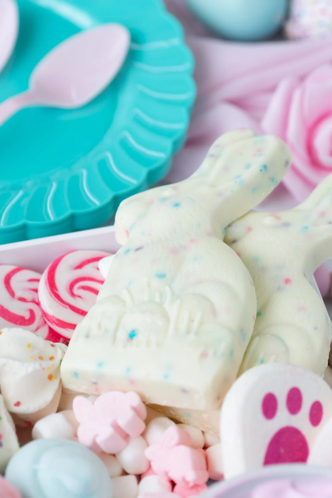 up close angled down view of white chocolate bunnies on a hot cocoa board