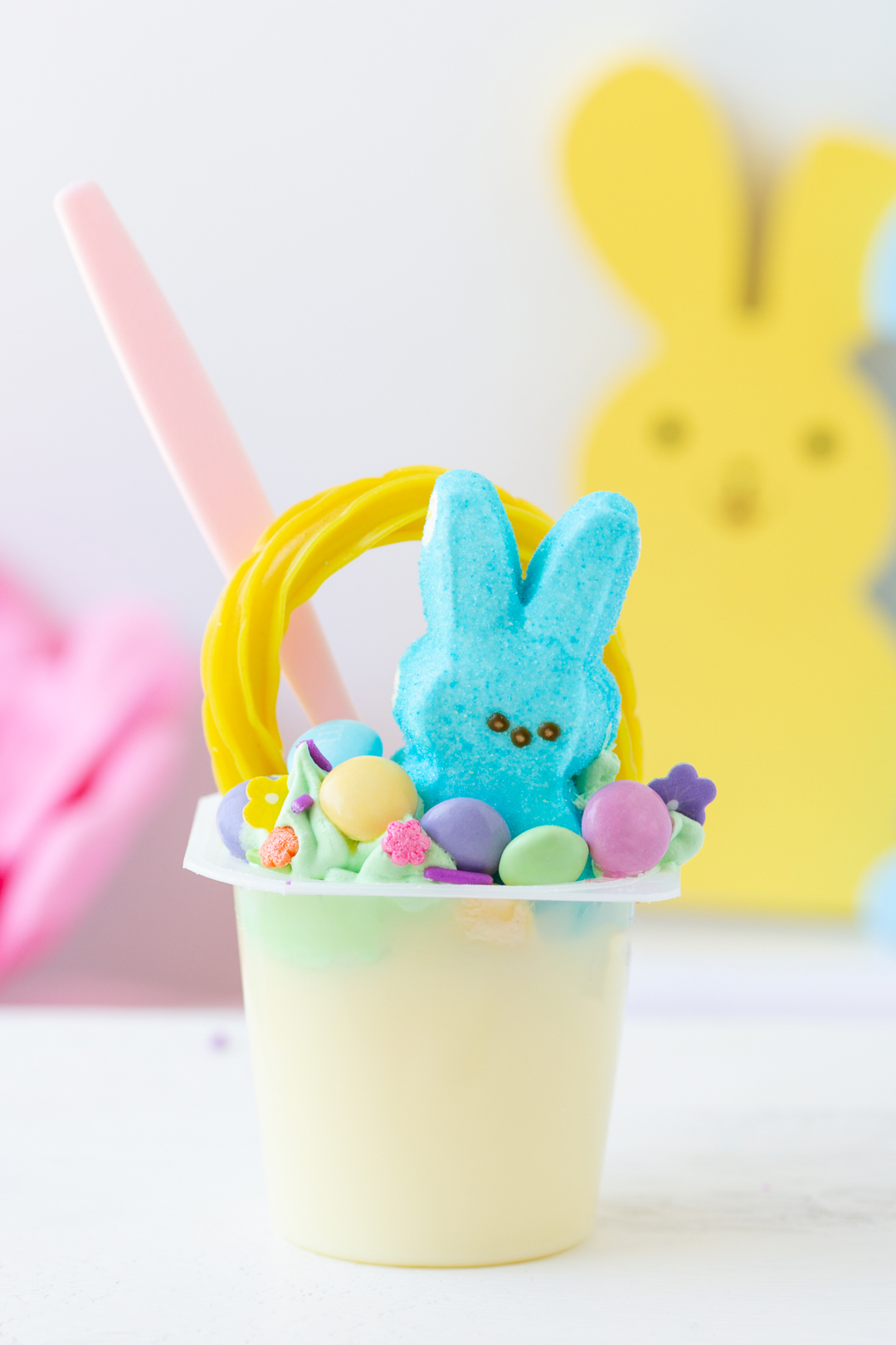 pretty pastel pudding cups for easter topped with a peeps and licorice strip