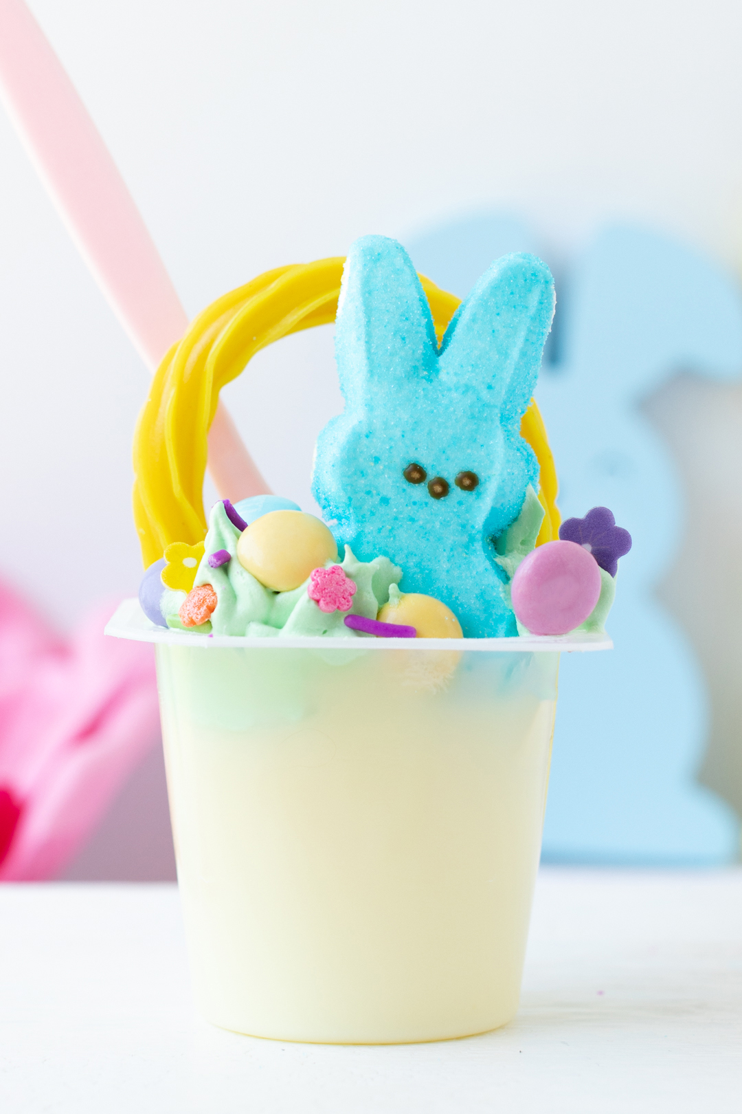 make these cute Easter Basket Pudding Cups using vanilla snack pack pudding cups, peeps and m&ms.