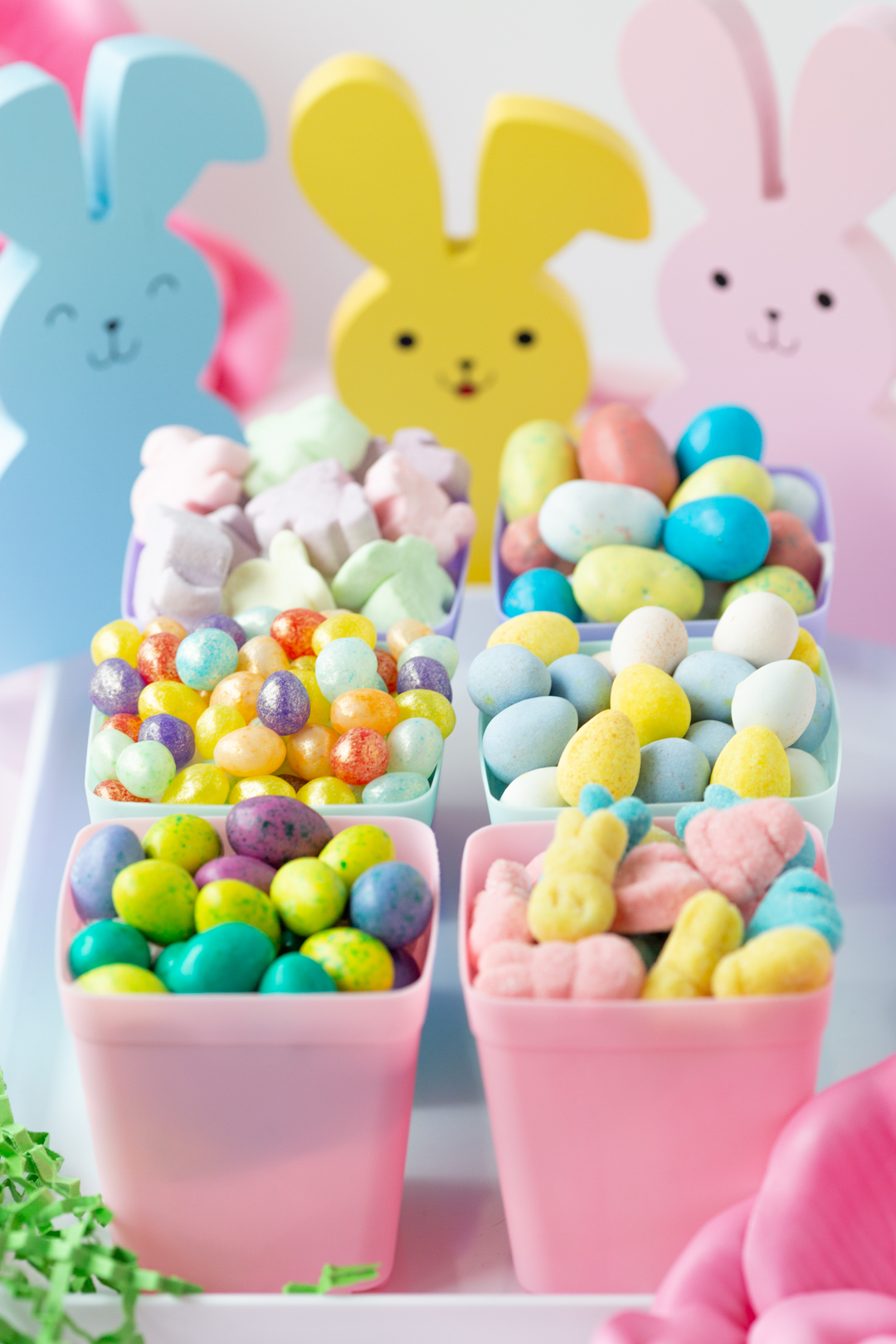 angled down view of easter candy inside pastel planters