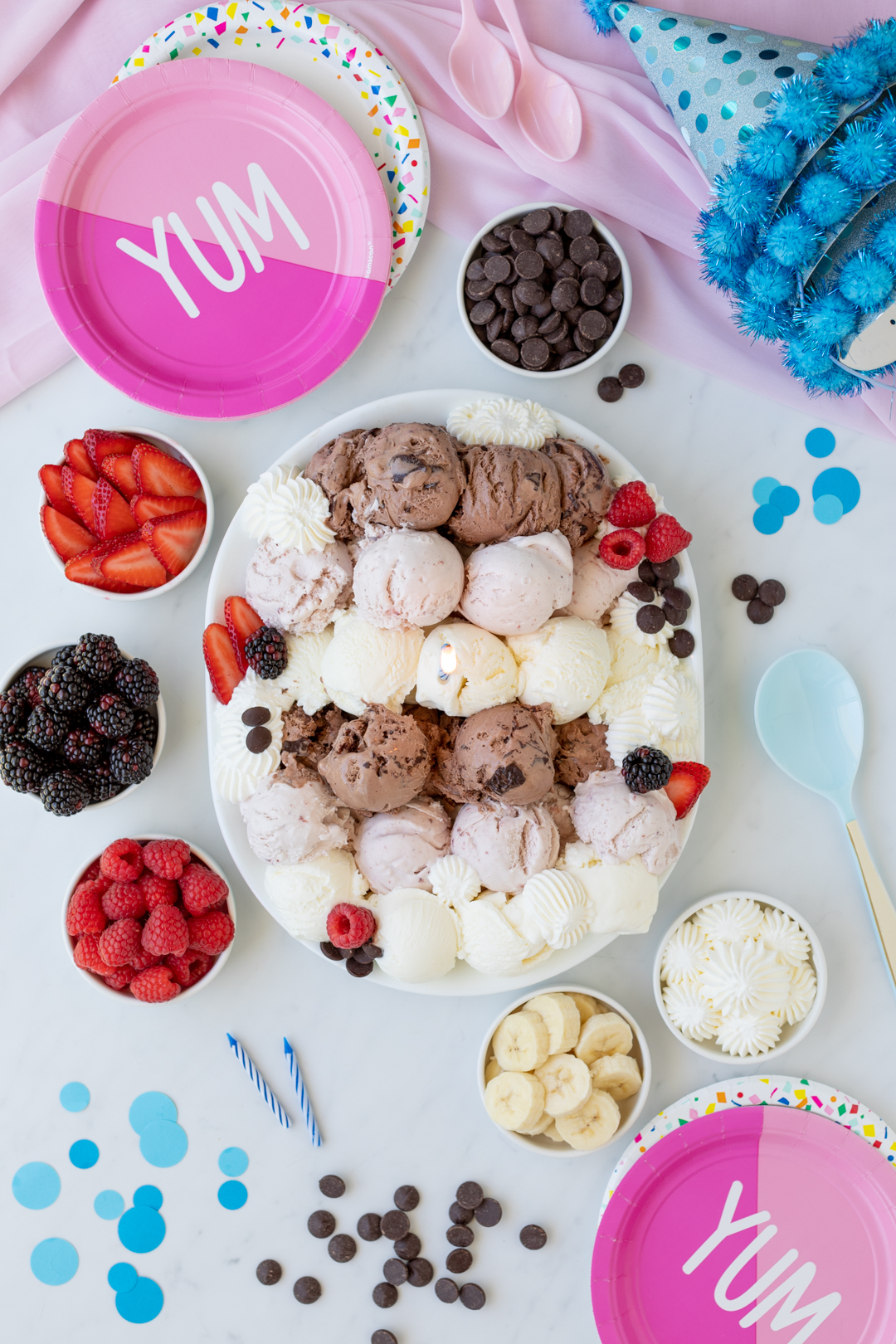 ice cream party spread with cute pink party plates and blue polka dot party hats