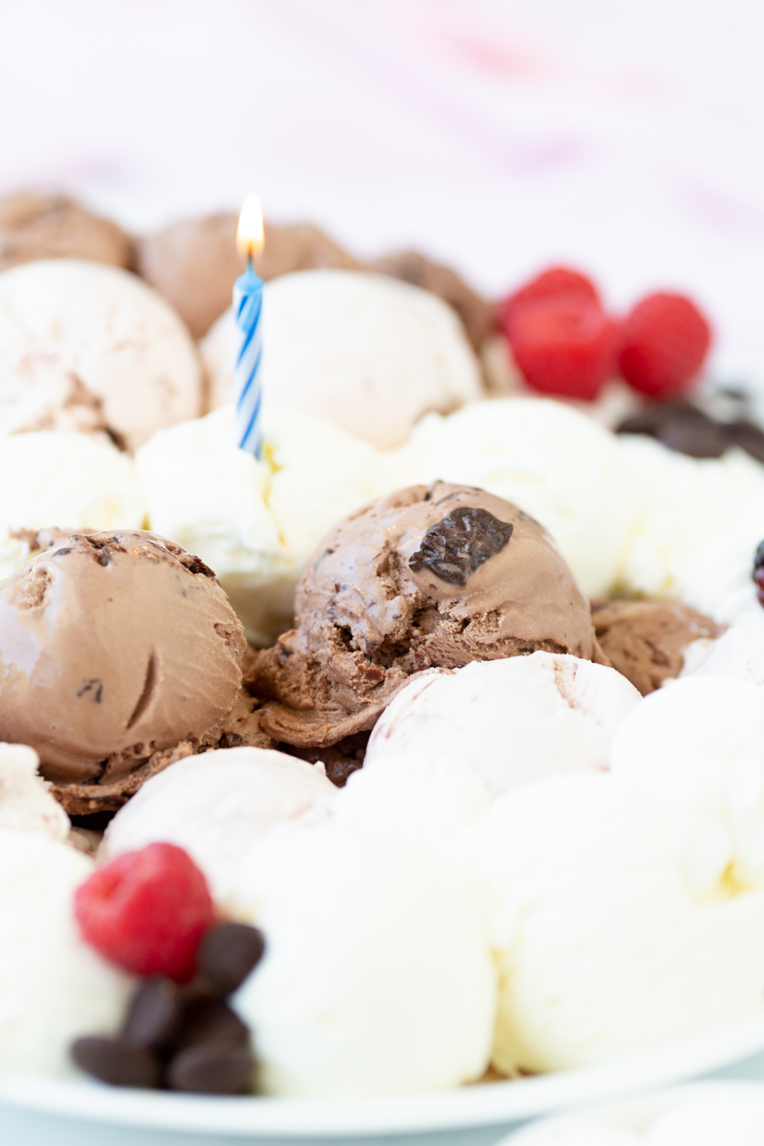 scoops of ice cream with a lit birthday candle on top to celebrate. cake alternative.