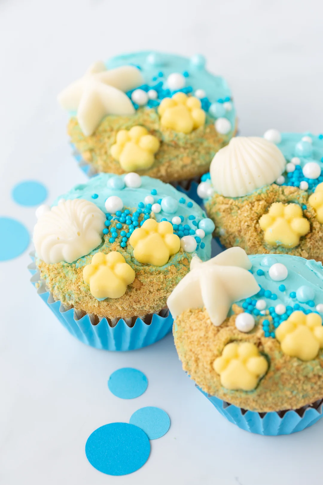 beach cupcakes with sprinkles and candy shells and starfish.
