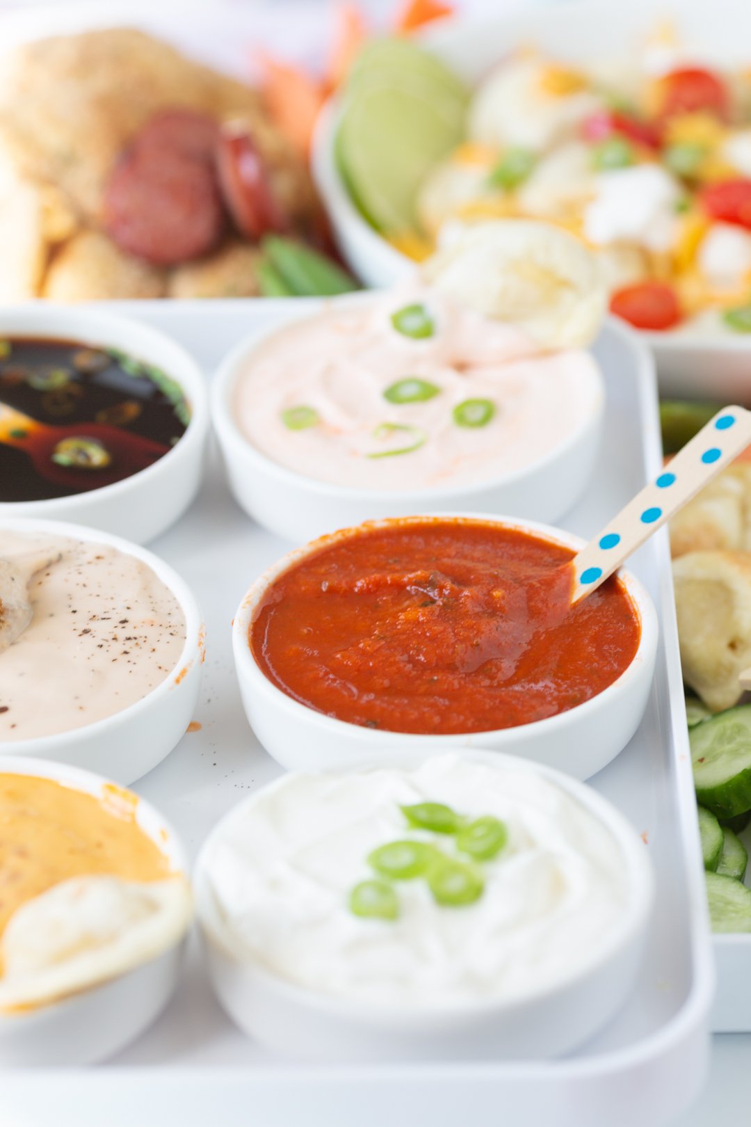 up close view of mini bowls filled with a variety of sauces