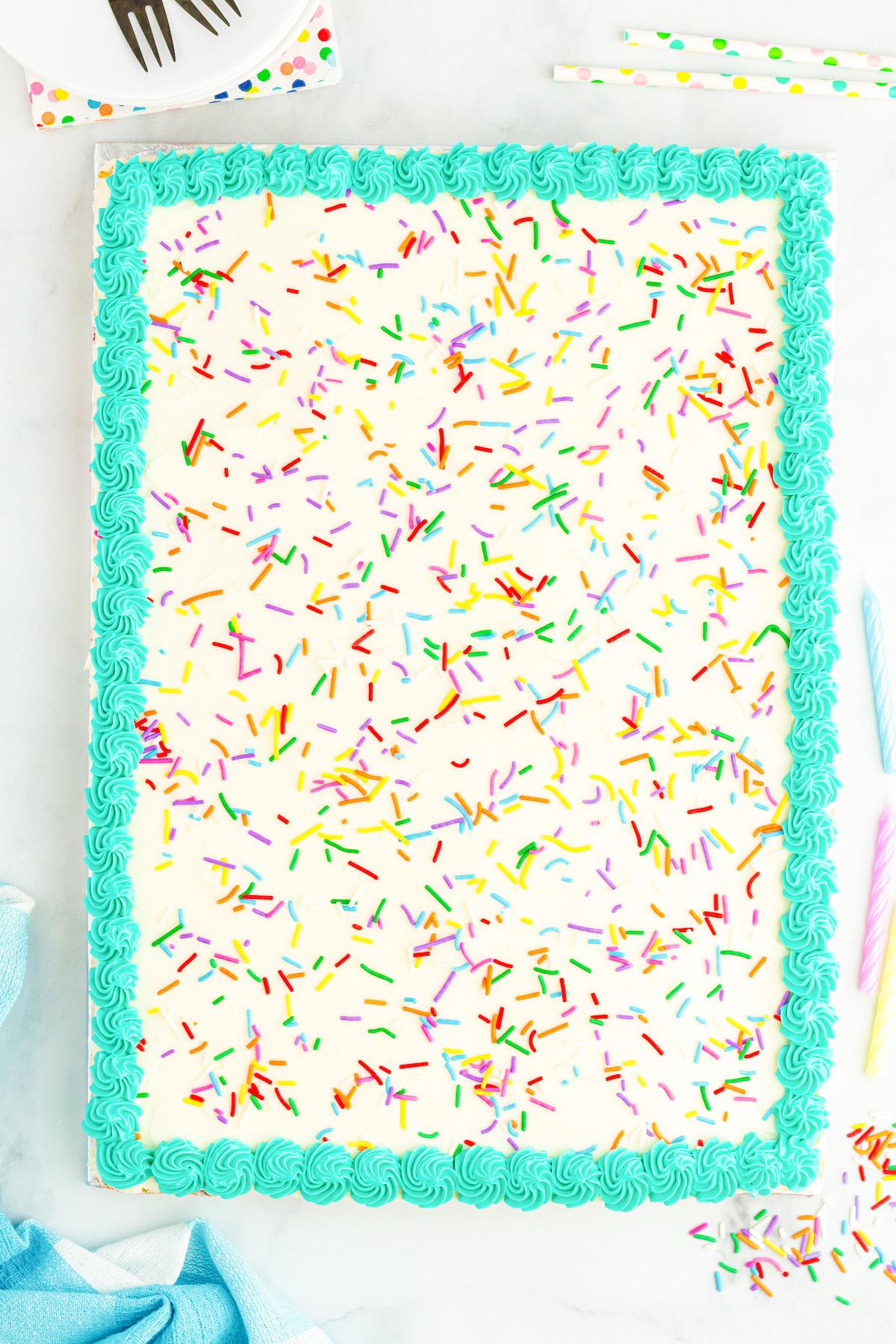 over head view of a confetti sheet cake with pretty teal border