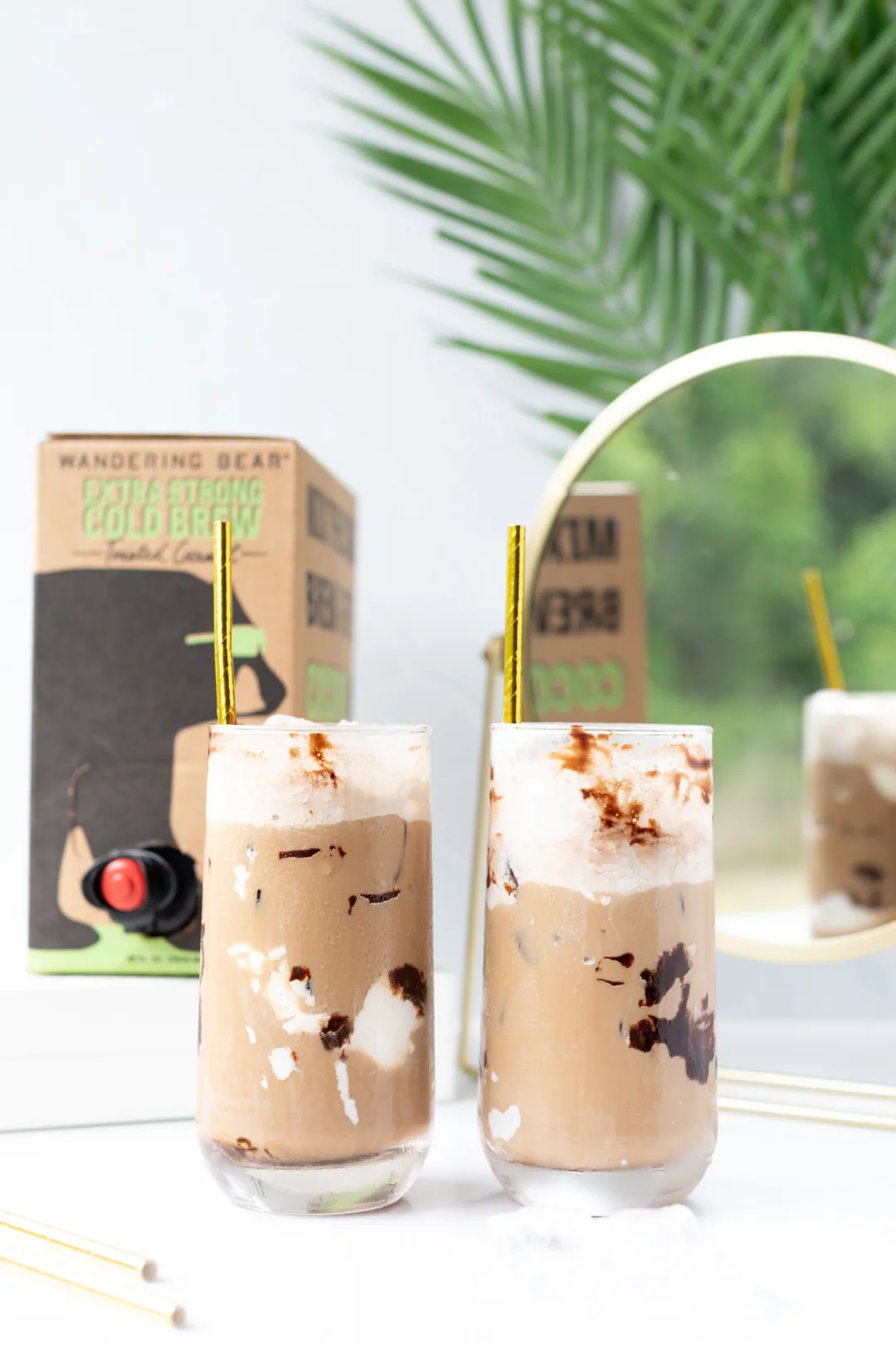iced coffee  glasses with palm leaves in the background