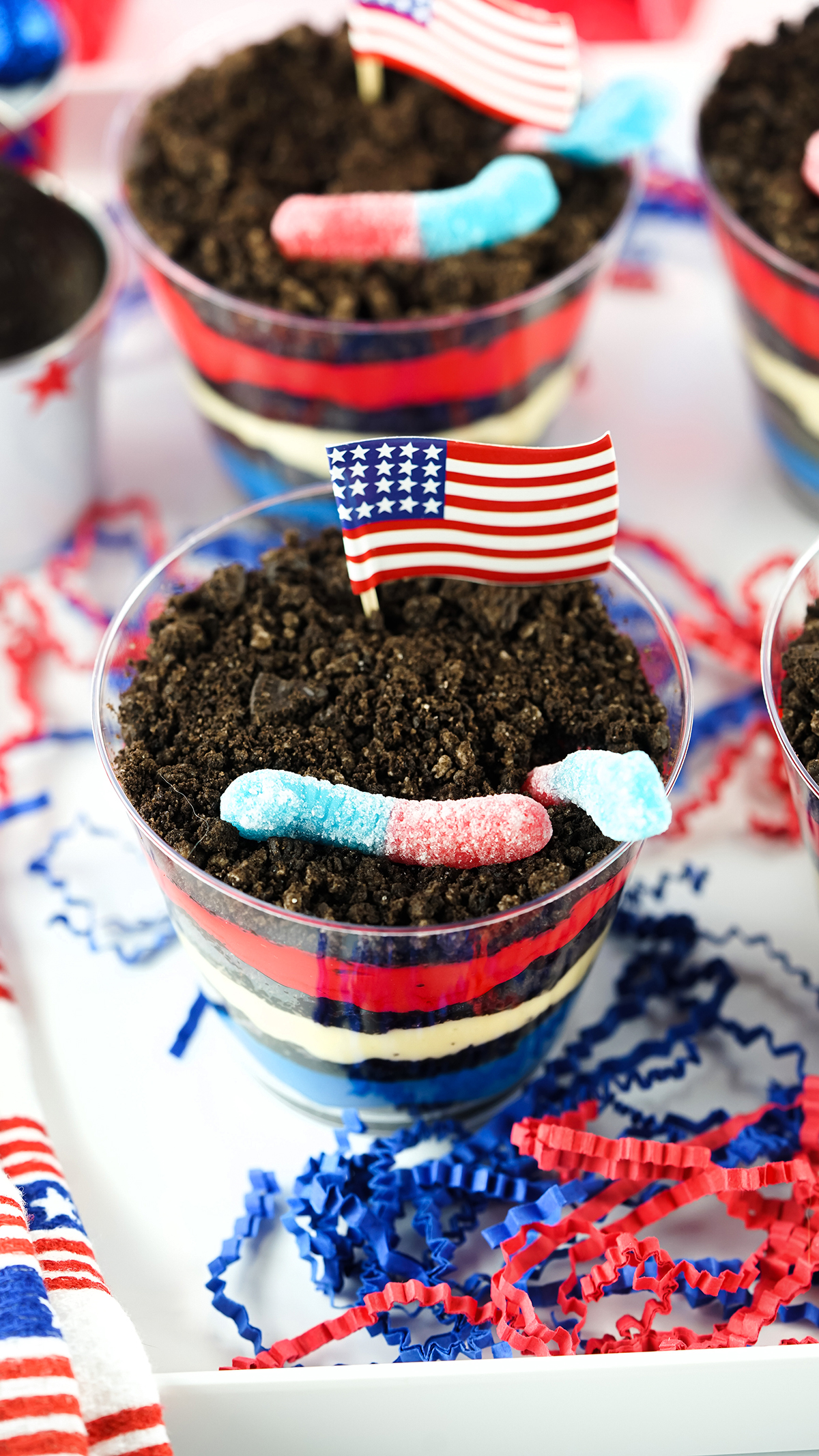 pretty patriotic dirt cups set on a white tray decorated with red and blue streamers