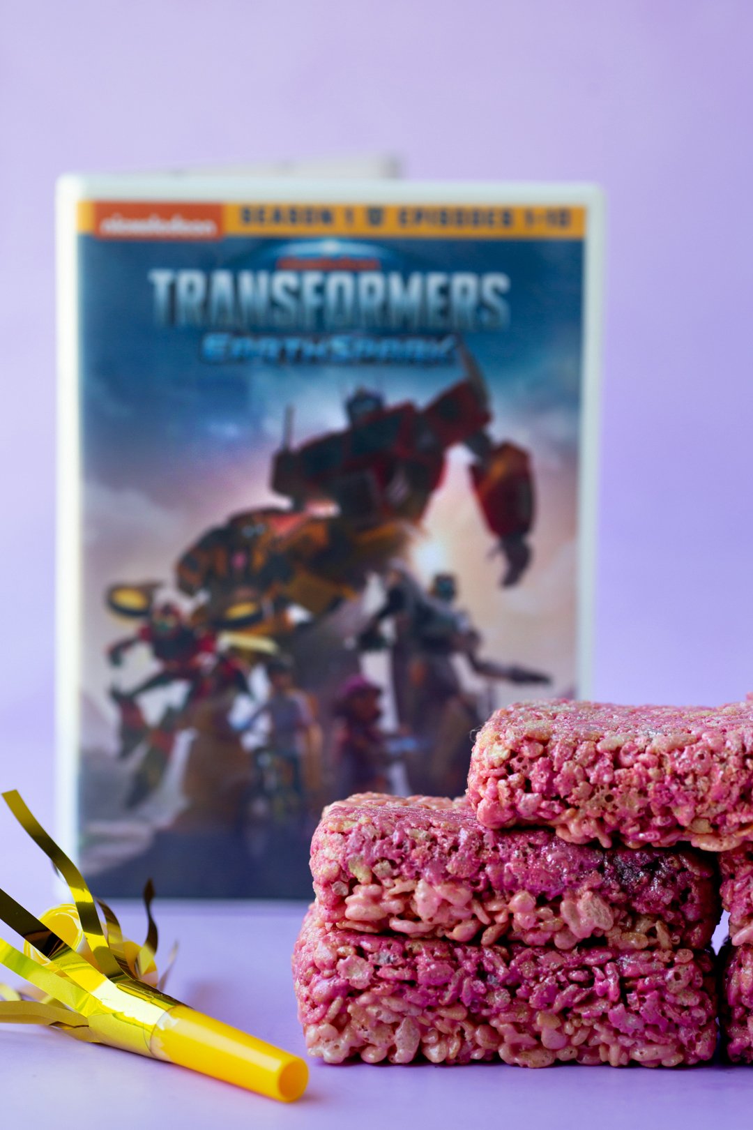 transformers earth spark dvd standing upright with energon rice krispy treats in front