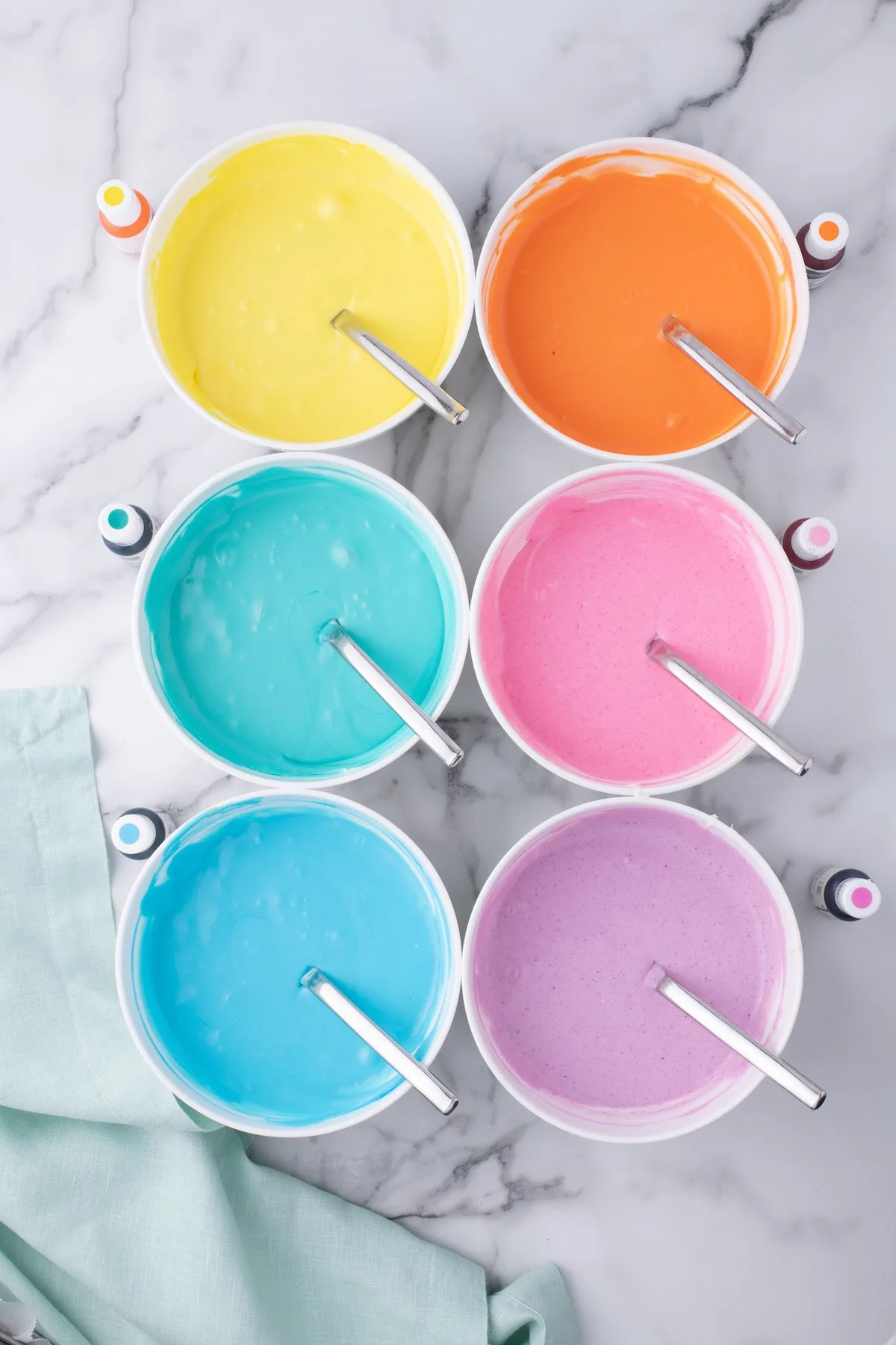 gorgeous bowls of pastel colored cheesecake mixture