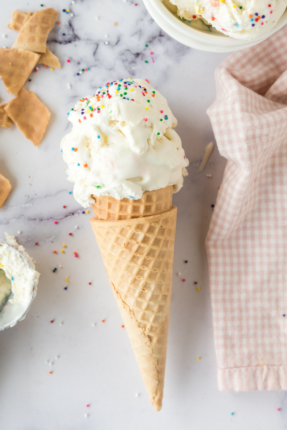 over the top photo of funfetti ice cream scoops in cone