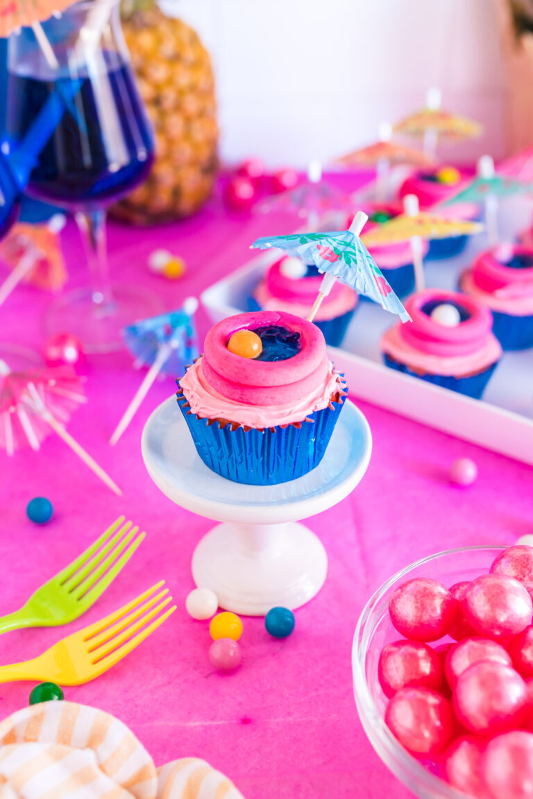 pretty pool themed cupcake made with blue jello and gum ball beach balls.