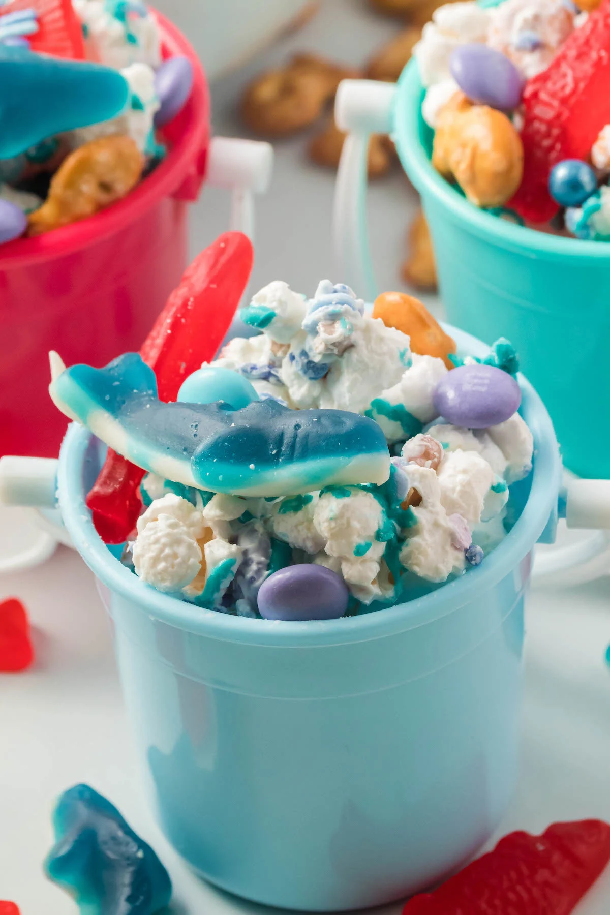 mini beach pails filled with party snacks