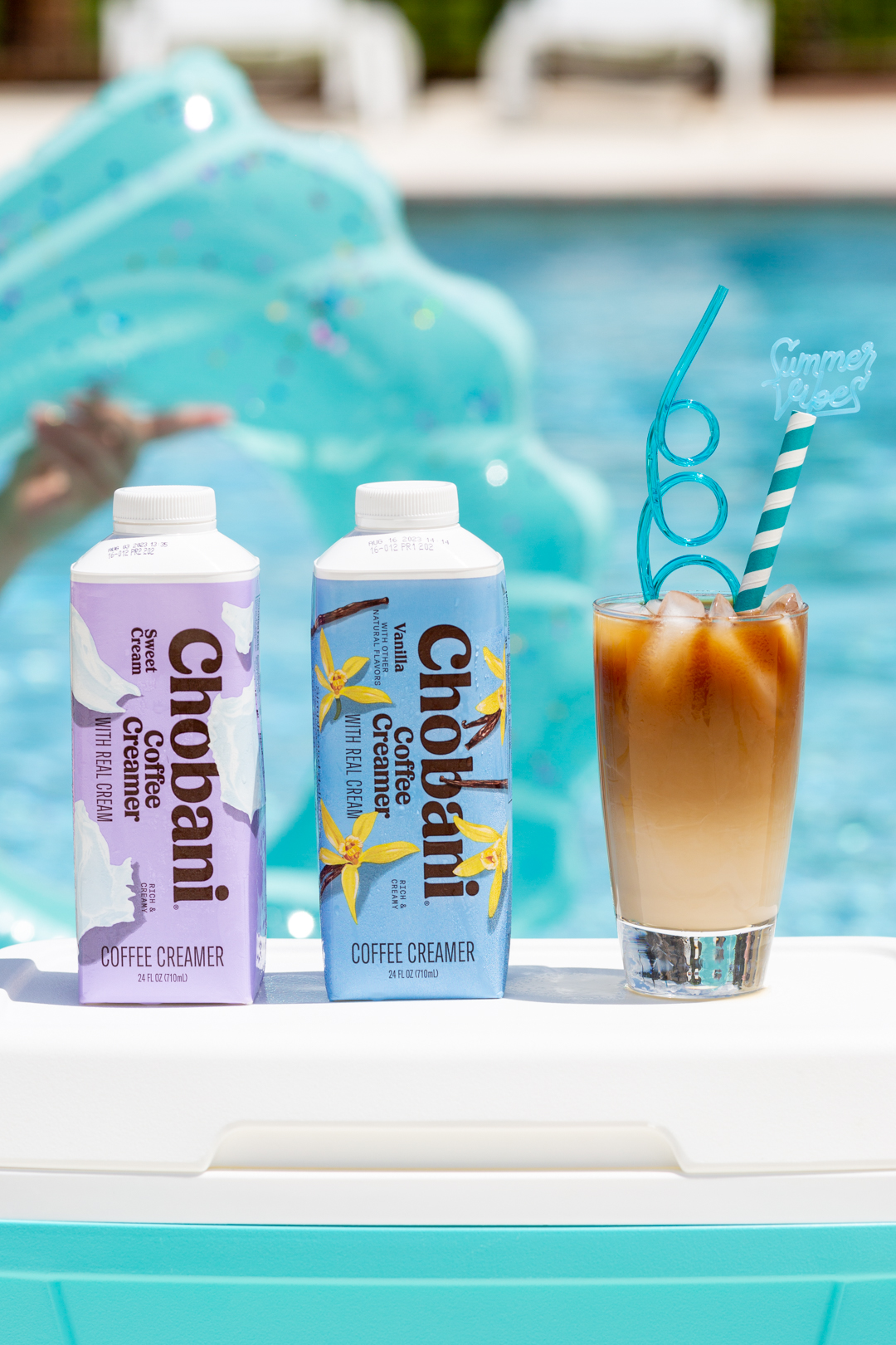 poolside iced coffee with chobani creamers. pool float in the background.