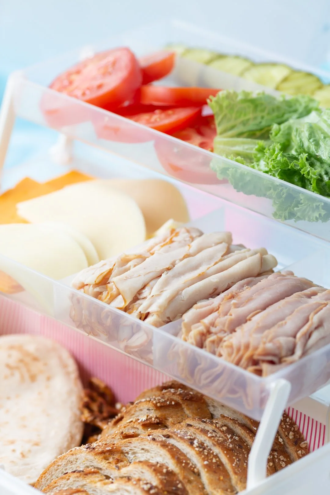 tackle box loaded with traditional sandwich fixings and toppings