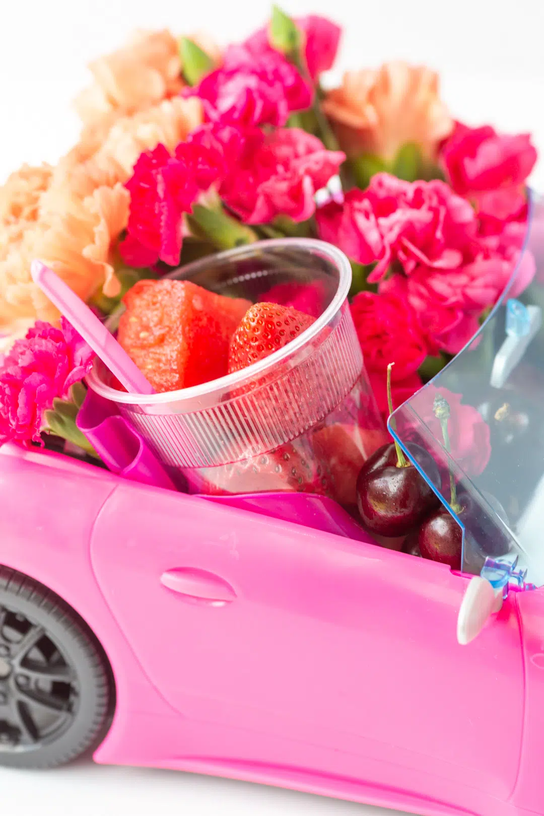 fruit and flowers put inside of a barbie car