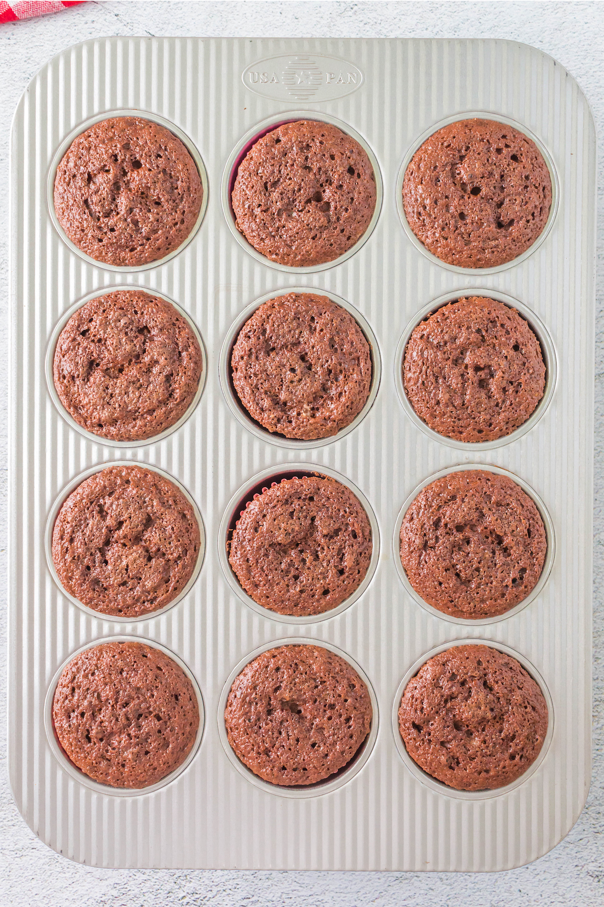 freshly baked chocolate angel food cupcakes in muffin tin