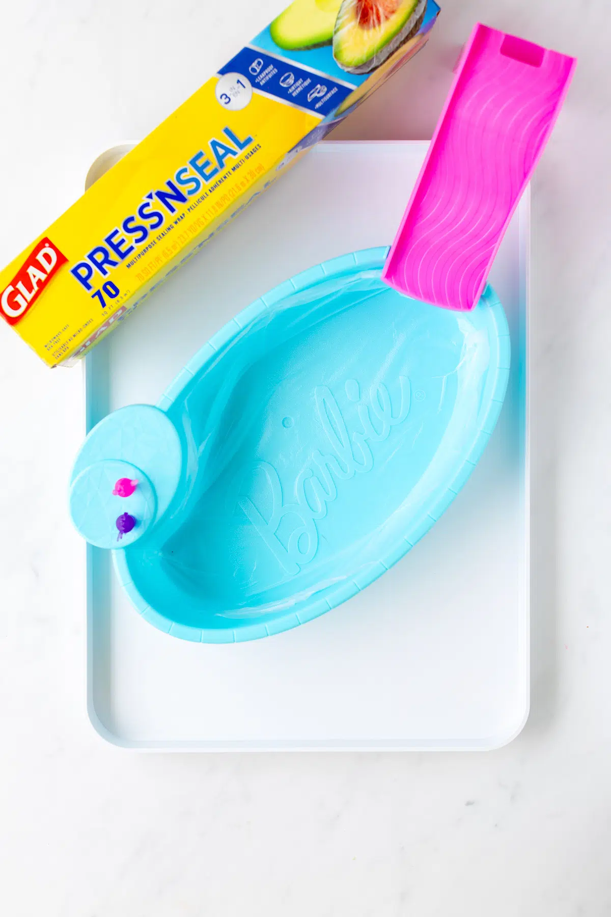 using press'n seal to coat barbie toy to use on food tray