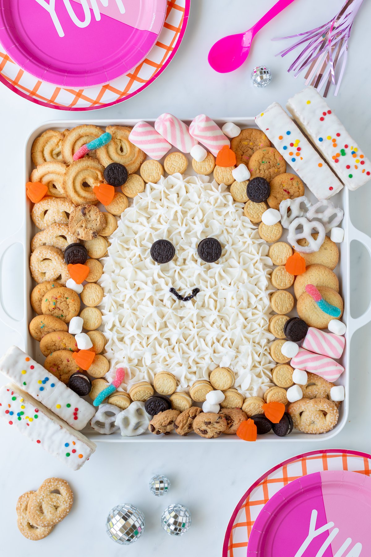 Cute ghost bootercream board with frosting and treats to dip into it.