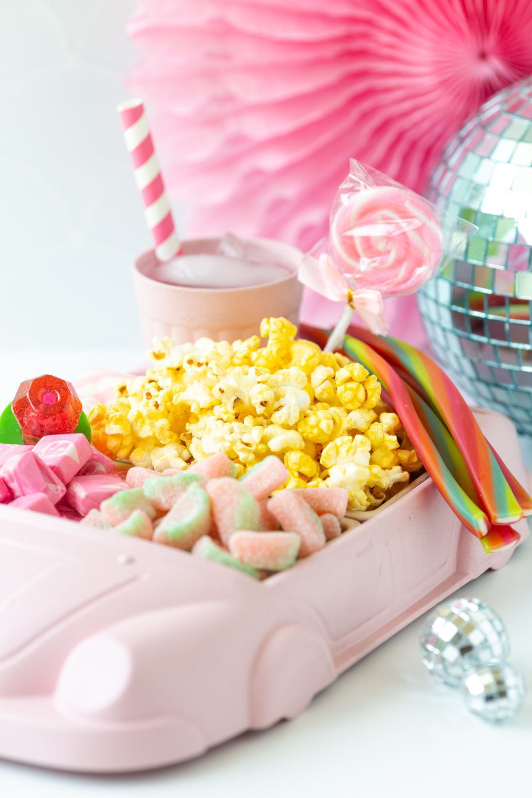 angled side view of movie night snack tray. cute pink car toddler dinner tray.