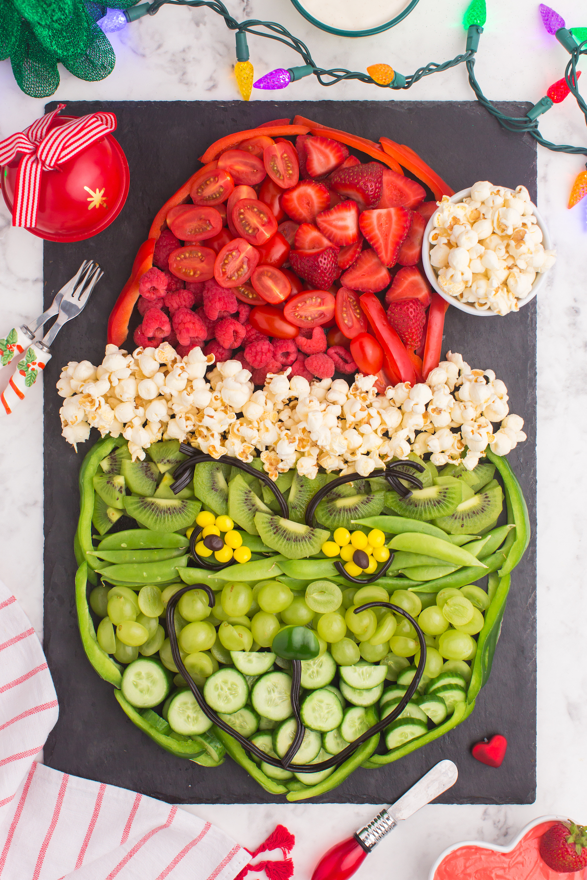 Grinch Christmas snack board with fruits and vegetables