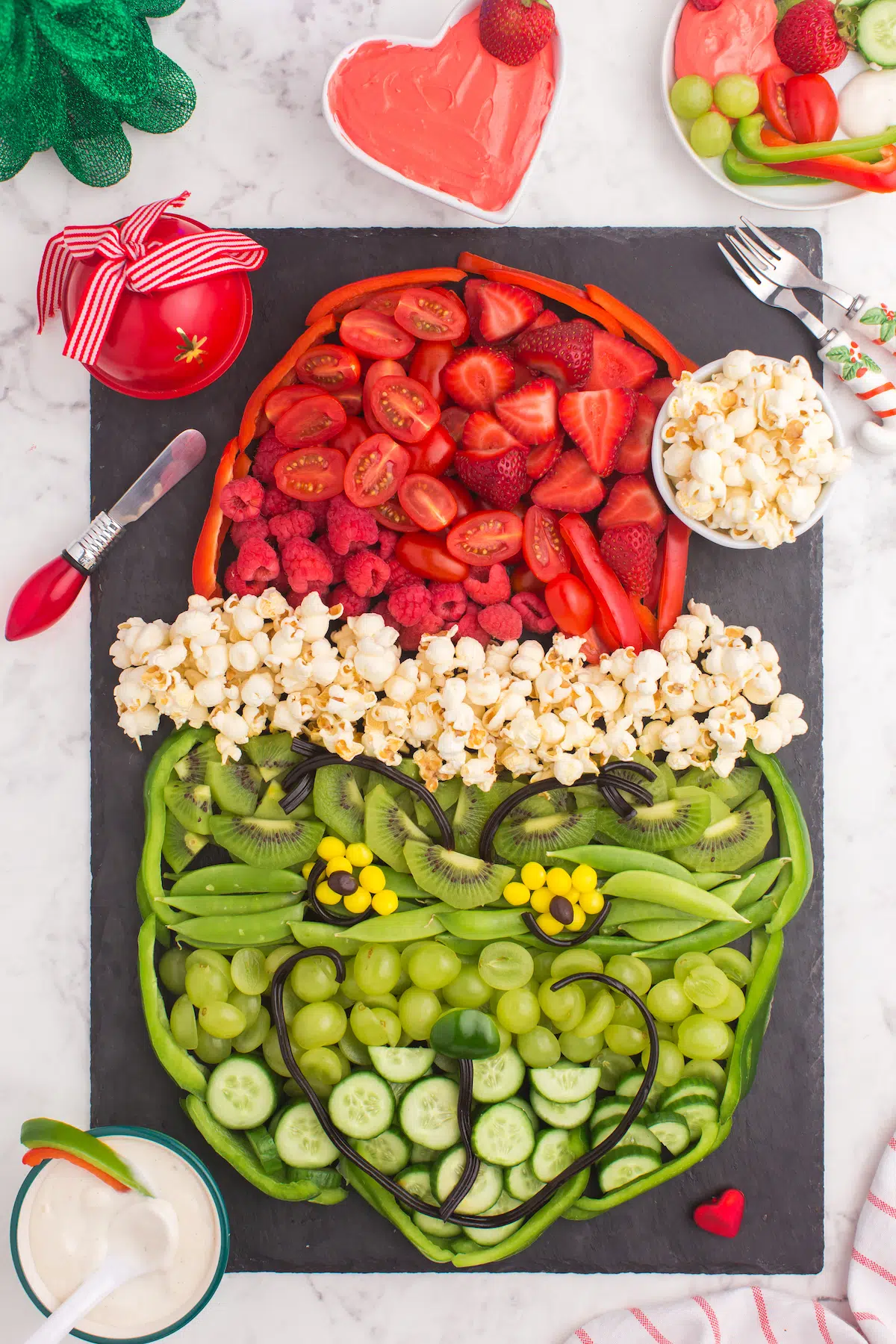 grinch face made with fruit and vegetables as a Christmas snack tray