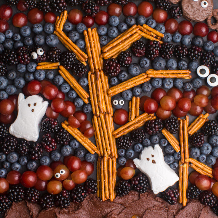 Spooky Forest charcuterie board with tree and ghosts, fruit and chocolate.