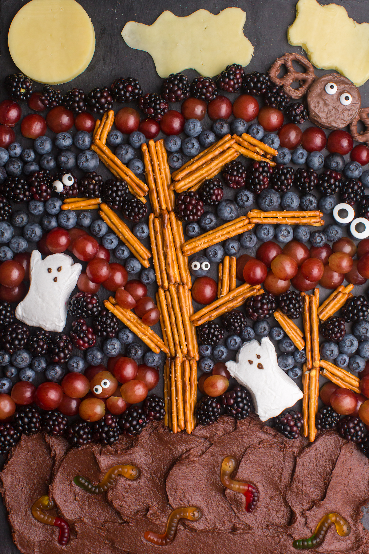 Spooky Forest charcuterie board with tree and ghosts, fruit and chocolate.