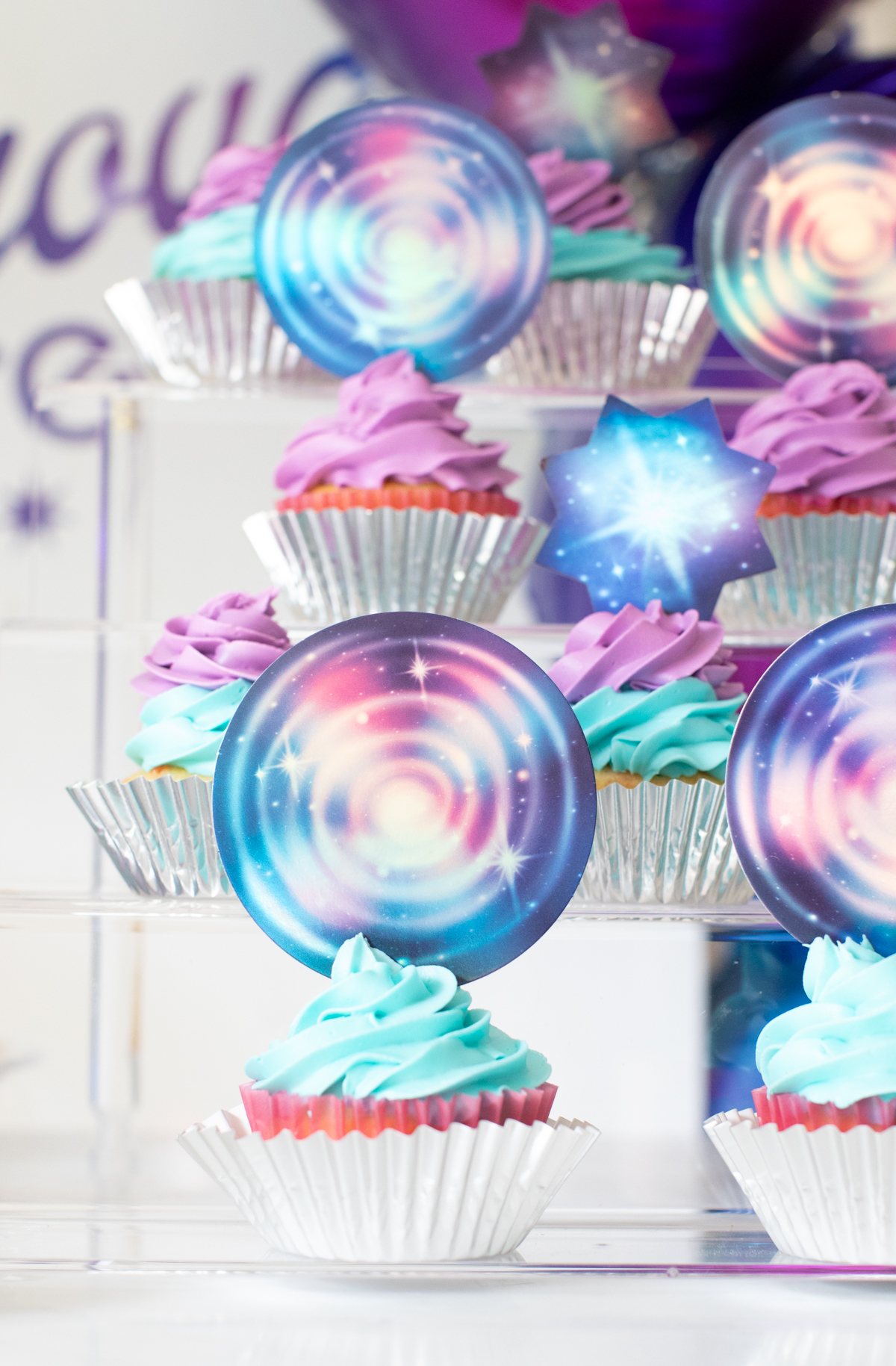 up close galaxy cupcakes on a tiered tray