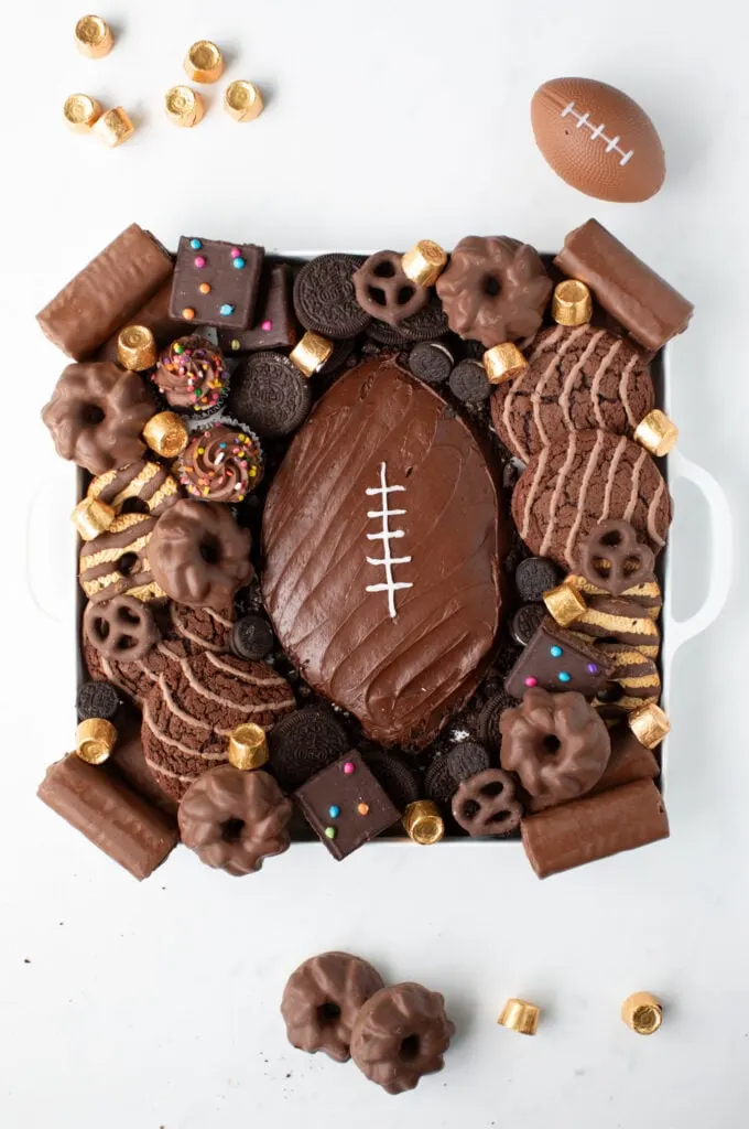 adding the desserts around the football dessert board