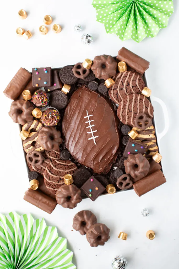 football frosting board with desserts around it
