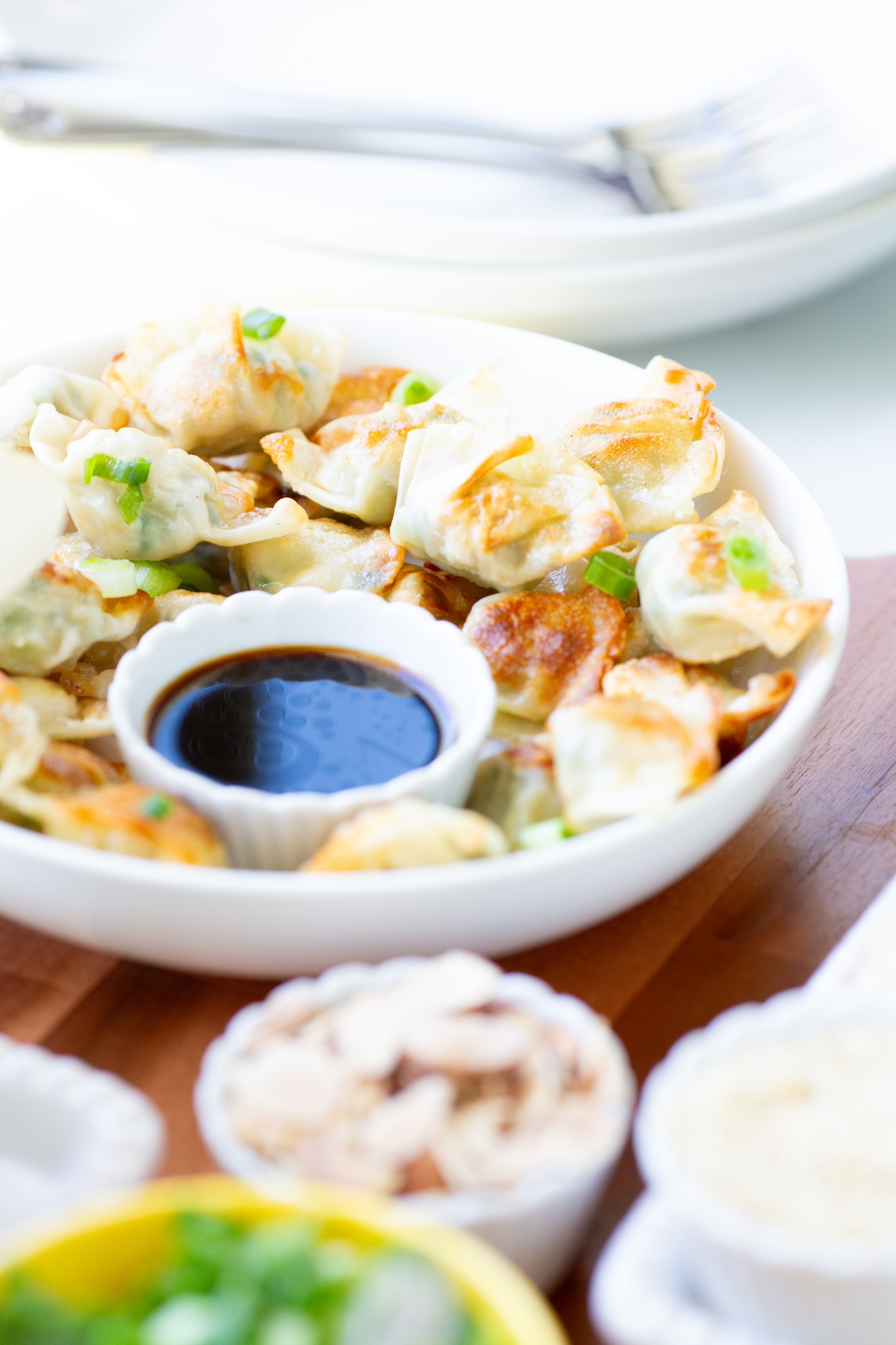 mini wontons in a serving dish with dipping sauce