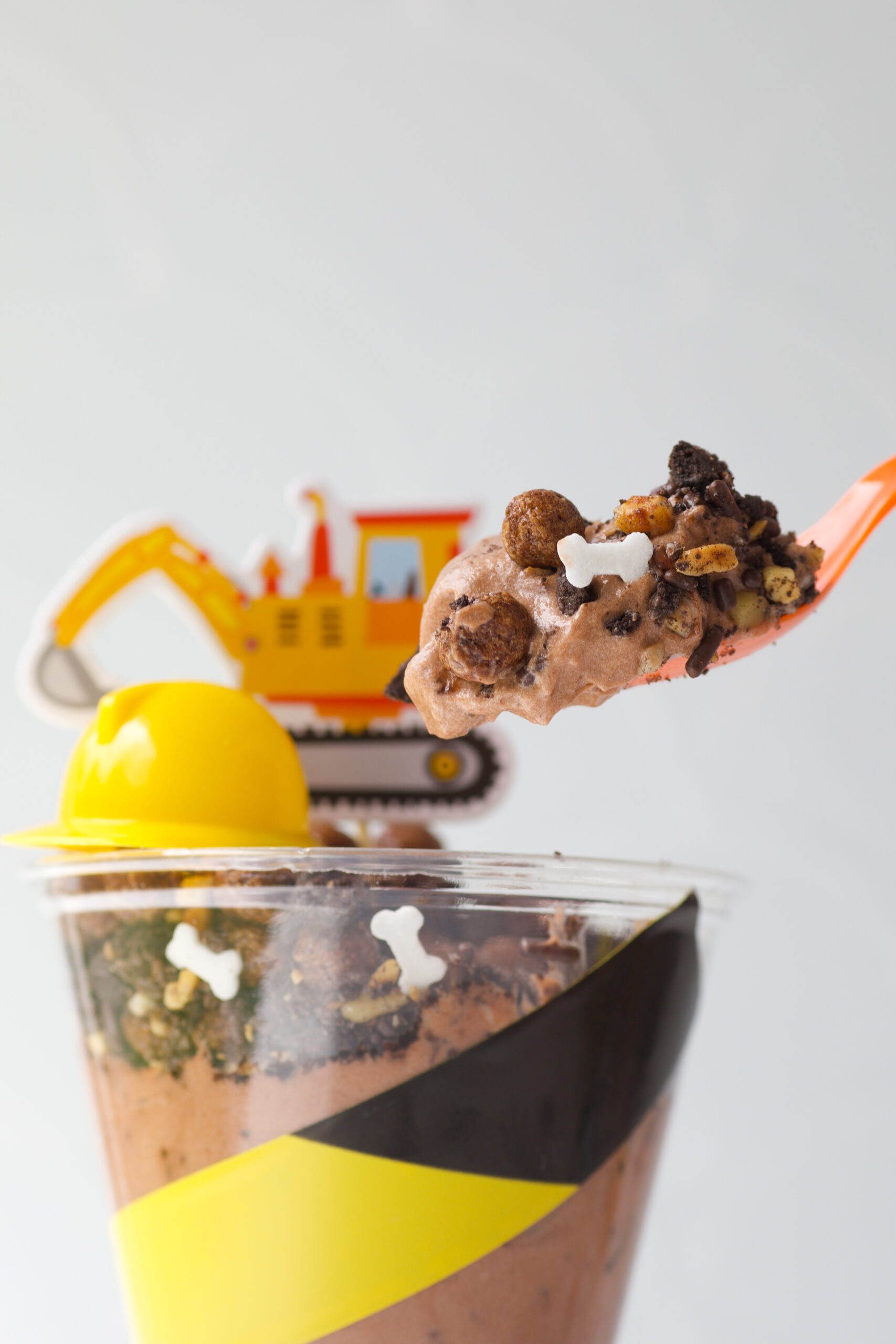 spoonful of dirt cup pudding and crushed cookies