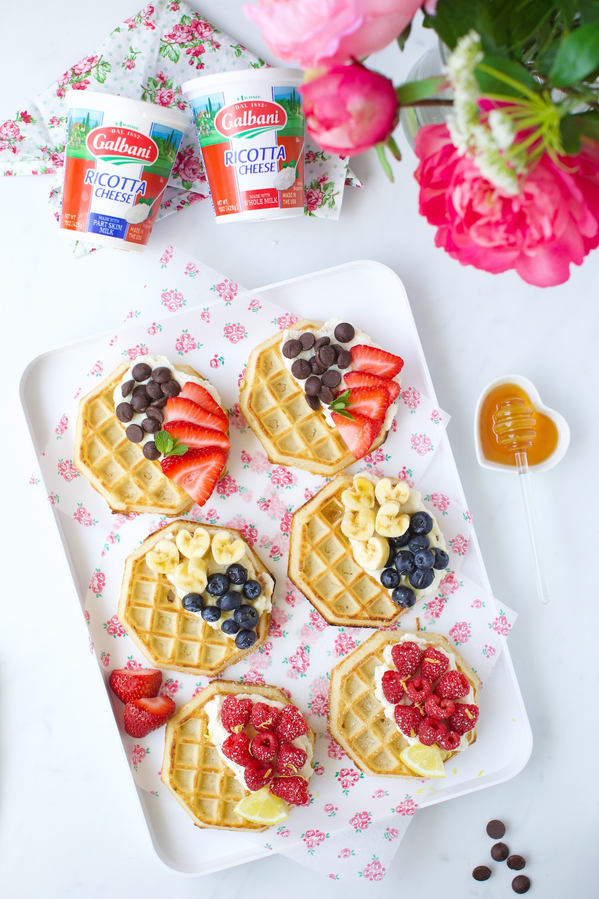 tray of ricotta topped waffles with fresh fruit.