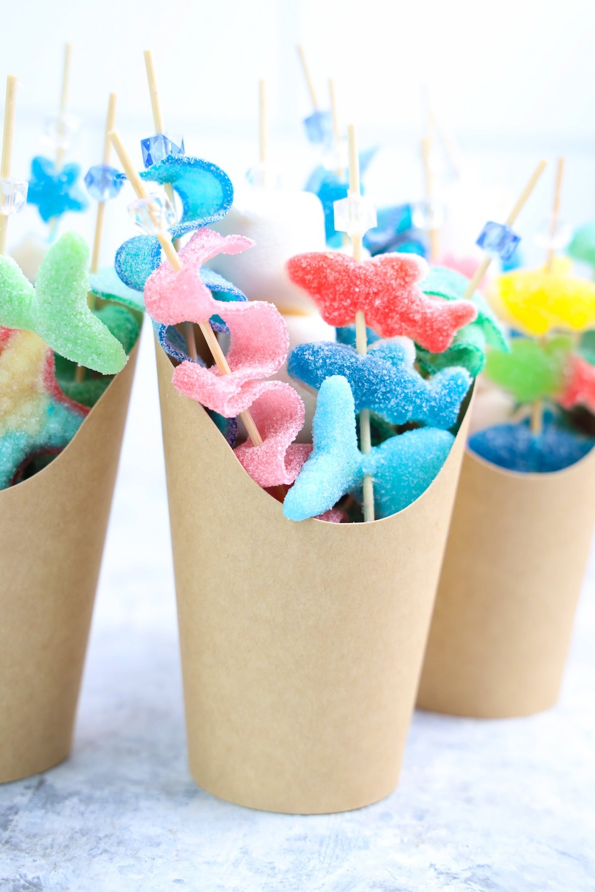 Beach Candy Charcuterie Cups with shark candies in a brown cup