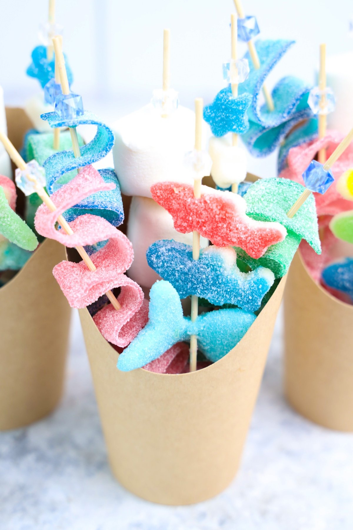 Beach Candy Charcuterie Cups with shark candies in a brown cup