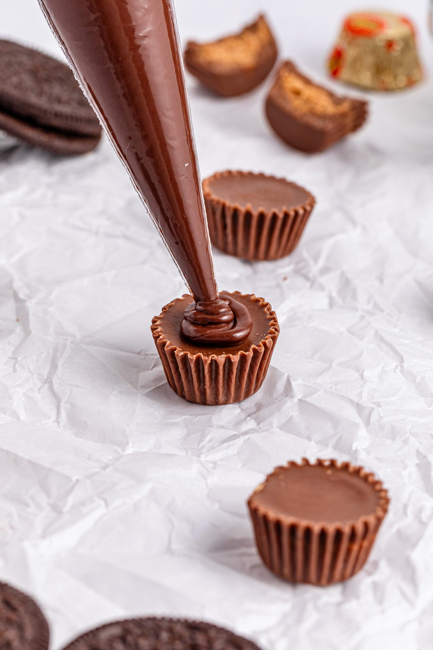 peanut butter cup with chocolate being added