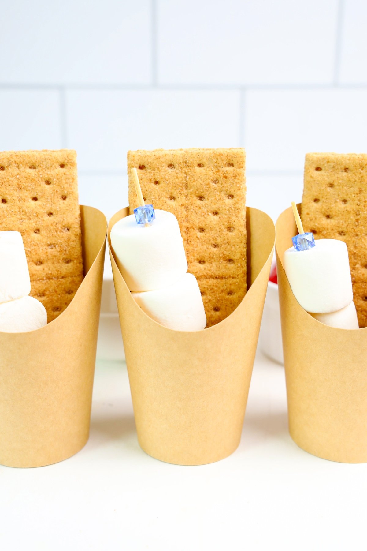 graham crackers and marshmallows in a brown cup