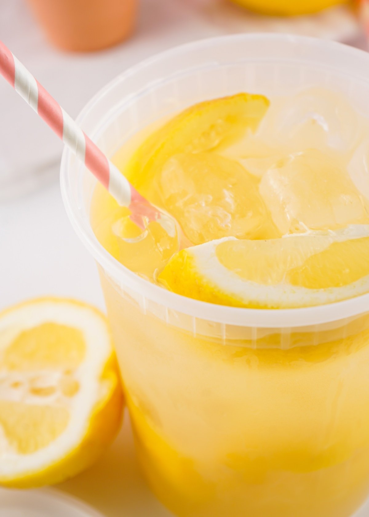 tiktok lemonade recipe with a pink and white straw