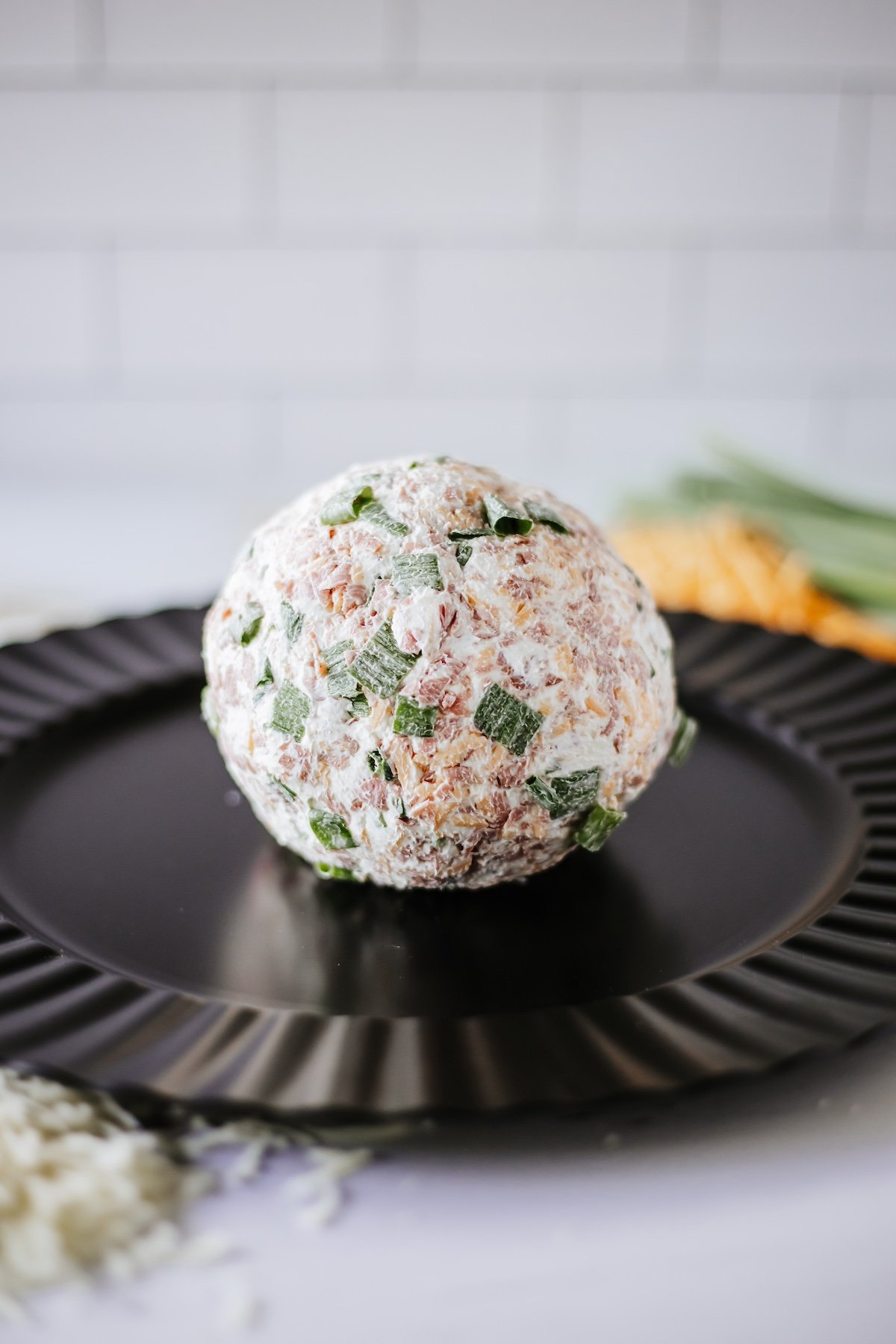 cheeseball on a black platter