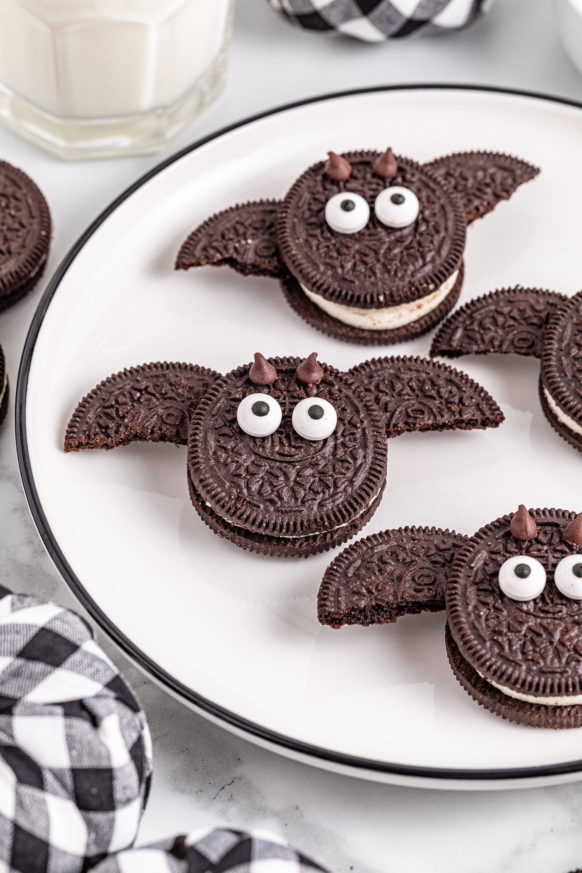 Double stuf Oreo bat cookies on a white plate