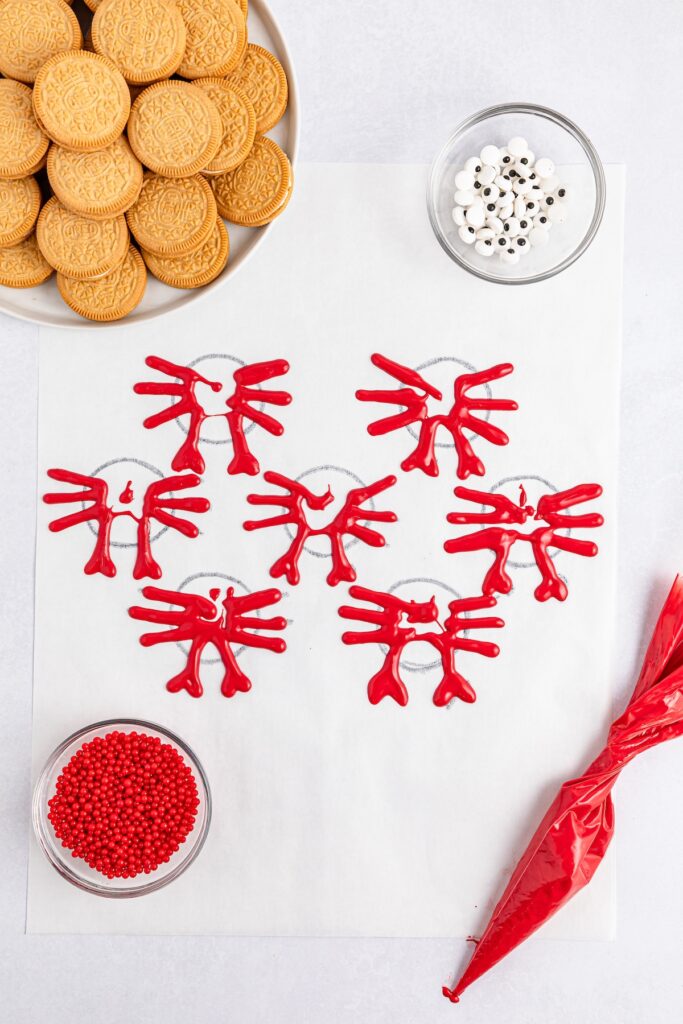 parchment paper with crabs drawn on it with red candy melts