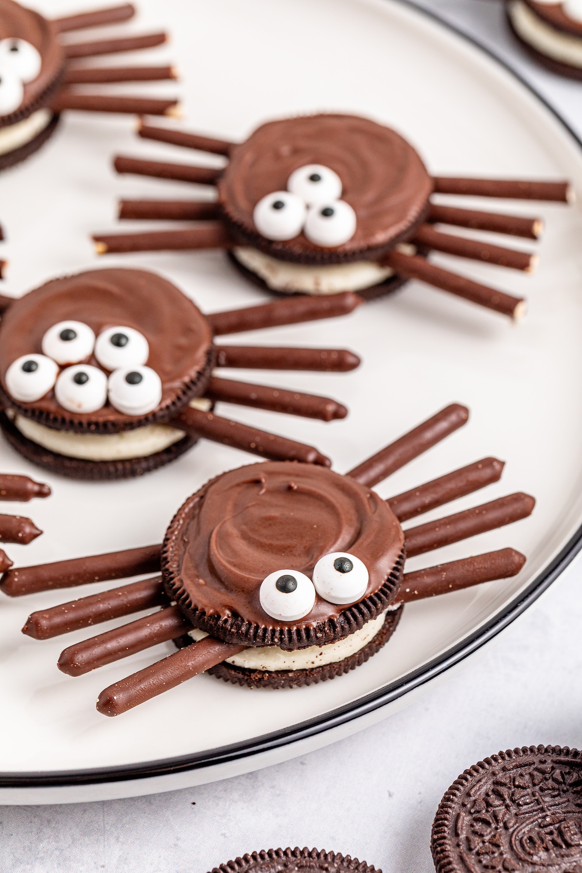 oreo spider cookies on a white plate