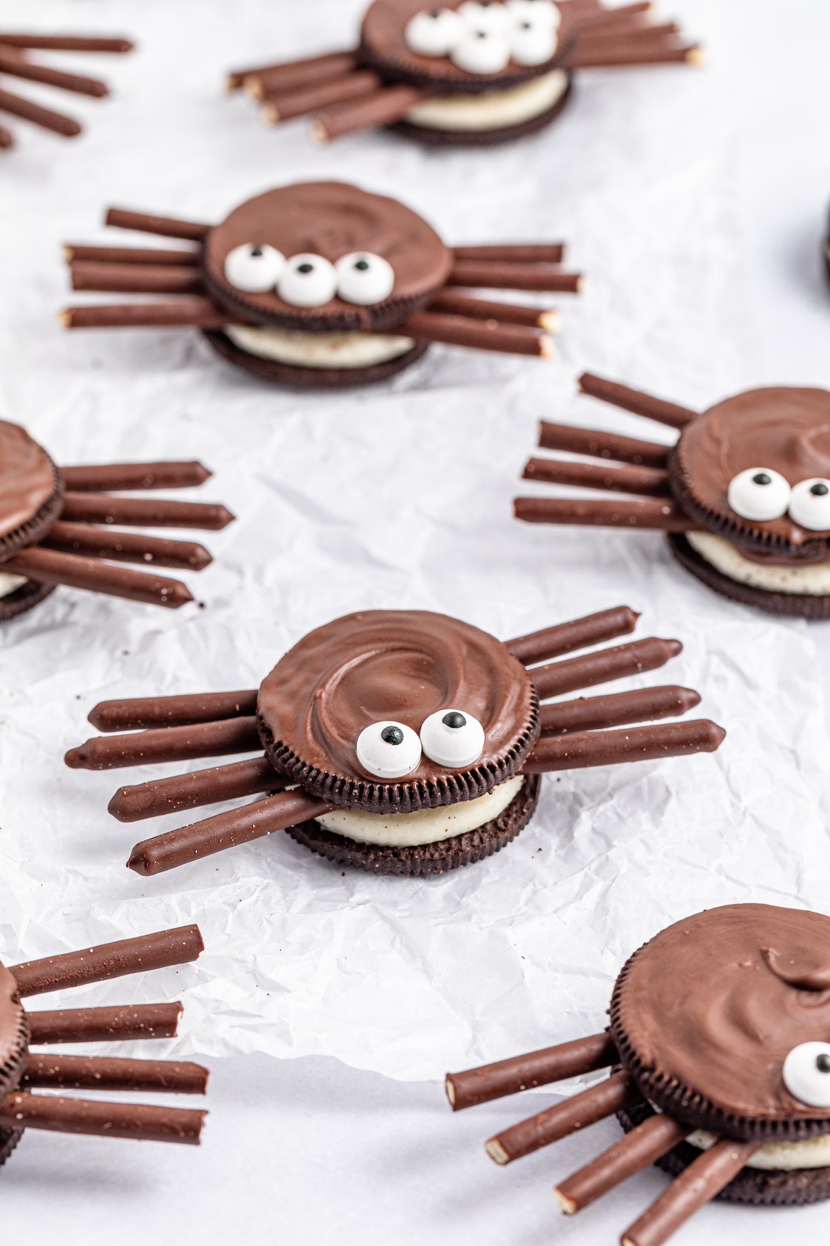 oreo cookie spiders on a parchment paper